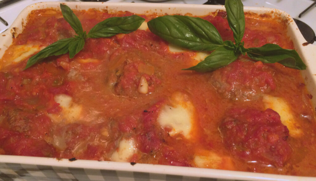 Mozzarella stuffed meatballs in a rich tomato sauce. Fresh out of the oven.